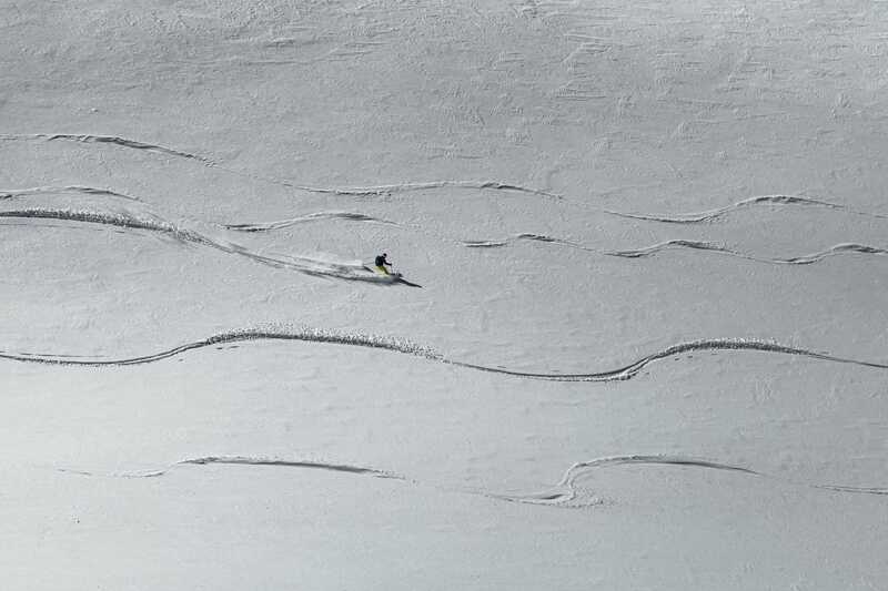 Snowboarder leaving the only track on an untouched slope above De&ccedil;an